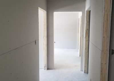 image of a hallway with recently put up drywall