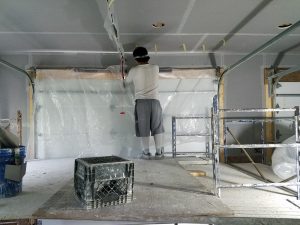 image of man installing blueboard with plaster